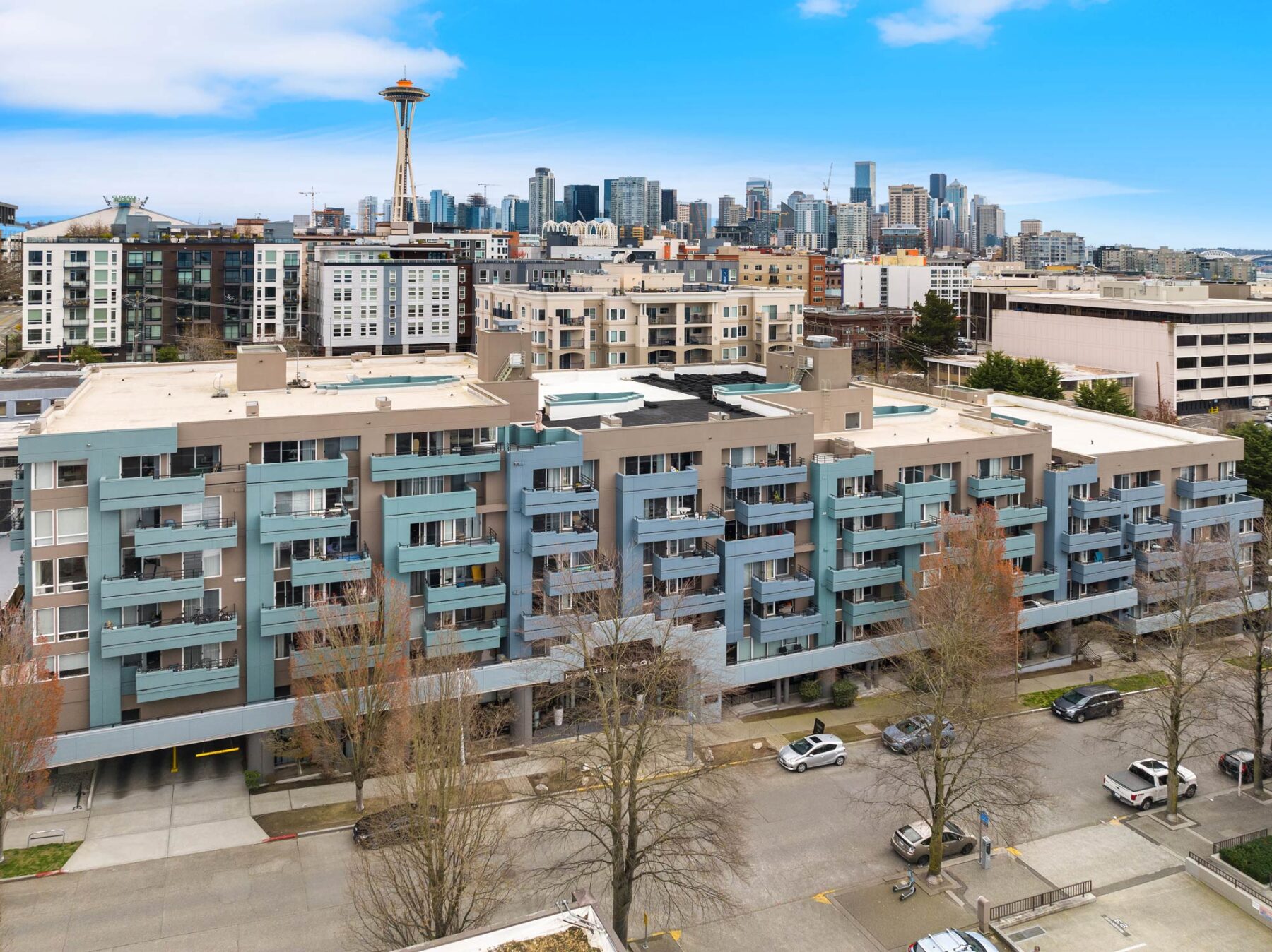 Exterior aerial view of the community building with Seattle skyline in background