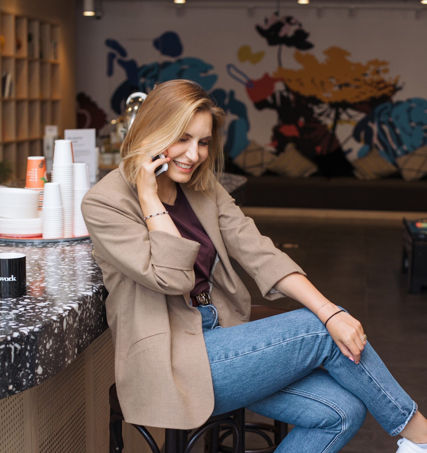 Woman sitting in a cafe talking on cell phone